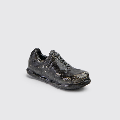 Side view of Miniature Pelotas Sculpture Ceramic shoe