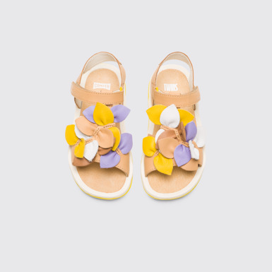 Overhead view of Twins Nude and multi-colored girl’s strappy sandal
